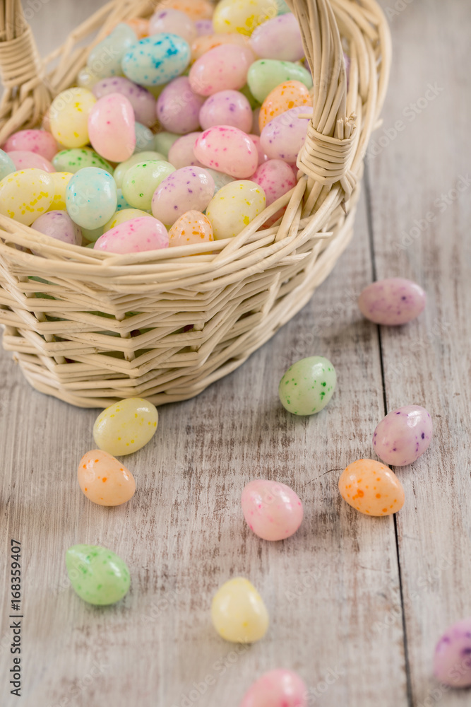 Close Up of pastel colored Easter egg cancy in wicker basket Close Up of pastel colored Easter egg cancy in wicker basket