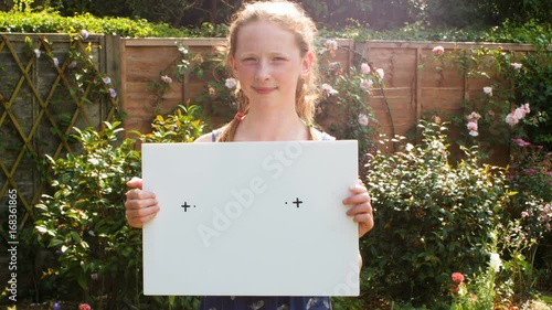 Pre teen caucasian girl holding a blank placard themes of billboard placard copy space advertising