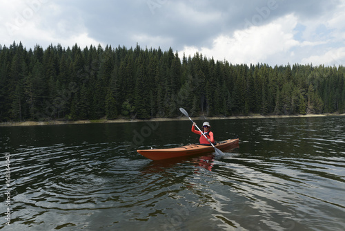 Woman paddling with her sit-in kayak