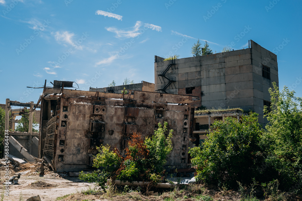 The territory of the abandoned factory, old abandoned buildings, metal structures