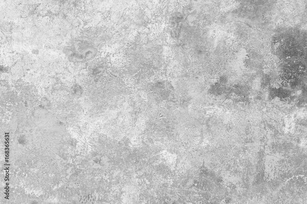 Close-up of a weathered and aged concrete wall, paint partly peeled off. Texture background in black and white.