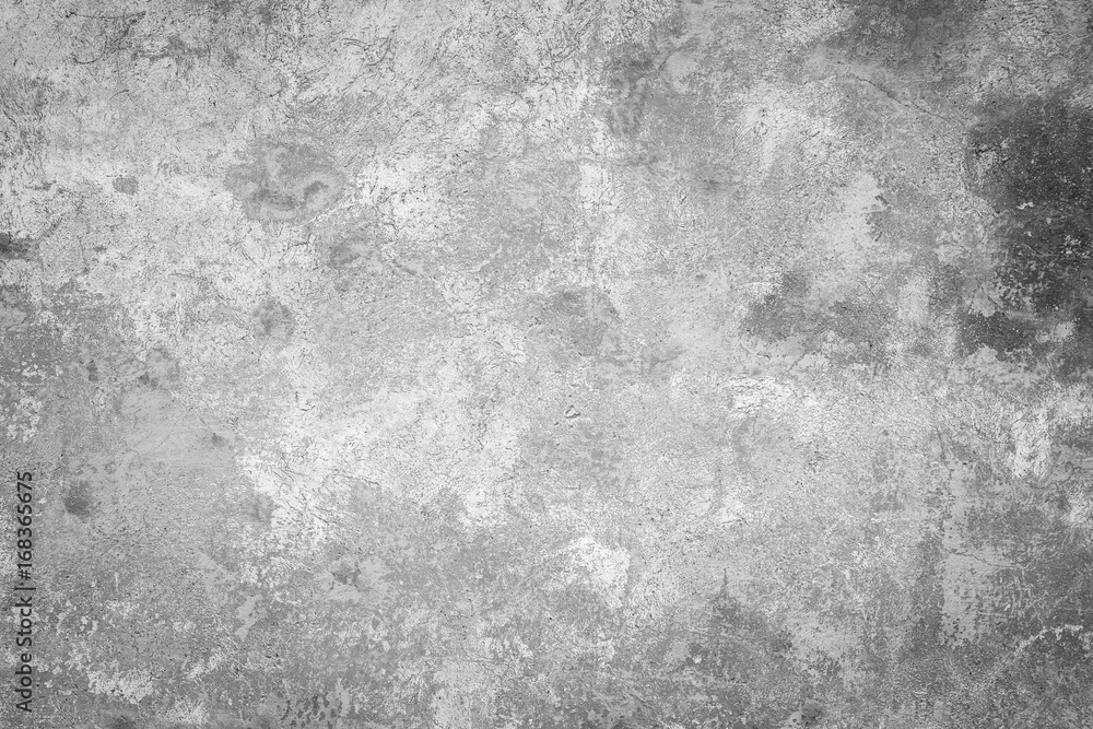 Close-up of a weathered and aged concrete wall, paint partly peeled off. Texture background in black and white with vignette.