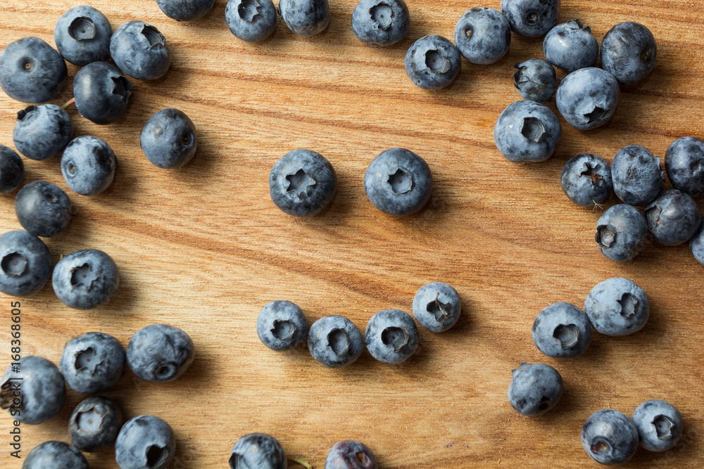 Smiley of ripe blueberries isolated on a brown background. Vitamins and antioxidants. Smiley of ripe blueberries isolated on a brown background. Vitamins and antioxidants.