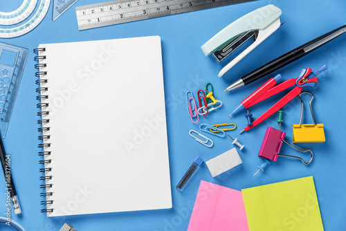 Notepad, School stationery and office supplies on color background.