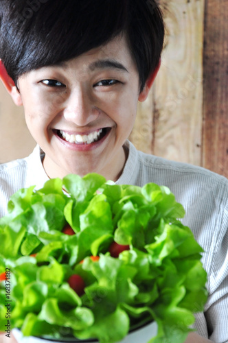 Asian Woman with Smiling Face Holding Salad Bowl