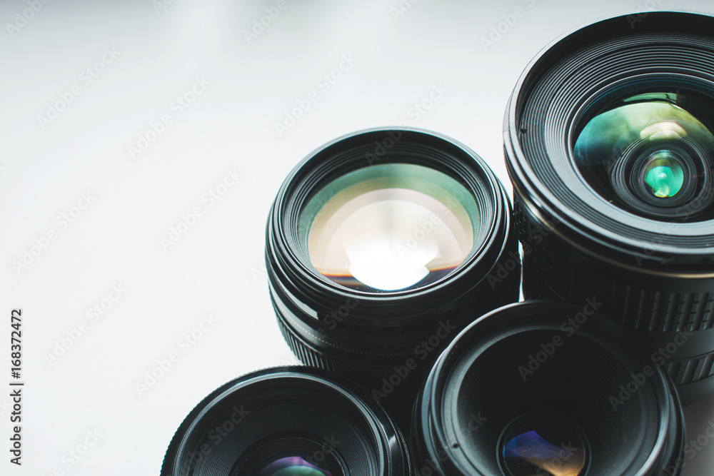 close-up view of a group of camera lenses on a white surface close-up view of a group of camera lenses on a white surface