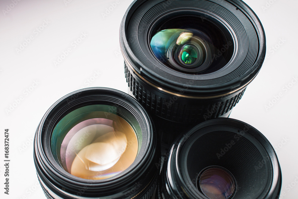 close-up view of a group of camera lenses on a white surface close-up view of a group of camera lenses on a white surface