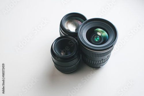 close-up view of a group of camera lenses on a white surface