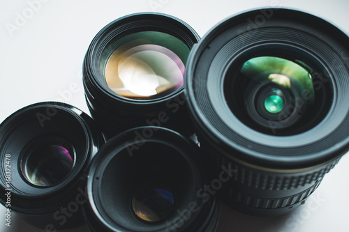 close-up view of a group of camera lenses on a white surface