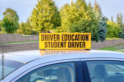 close up of drivers ed car with student driver sign on roof