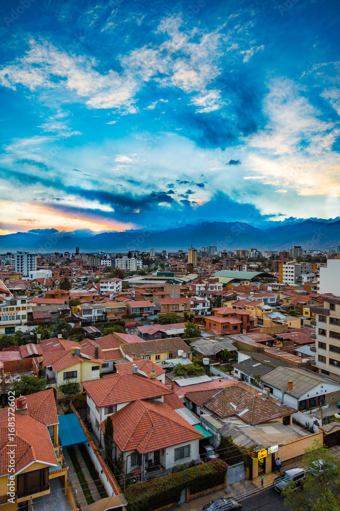View of cloudy sunset and houses in neighborhood in Cochabamba Bolivia in South America