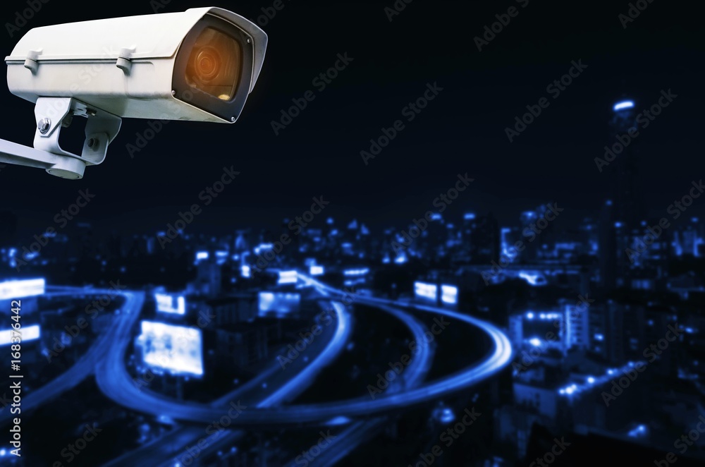 CCTV, security camera system operating record and property protection with blurred night city background, surveillance security technology, concept, color tone effect