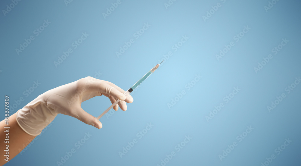 Female doctor holding syringe Female doctor holding syringe