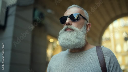 Confident mature man promenading in downtown