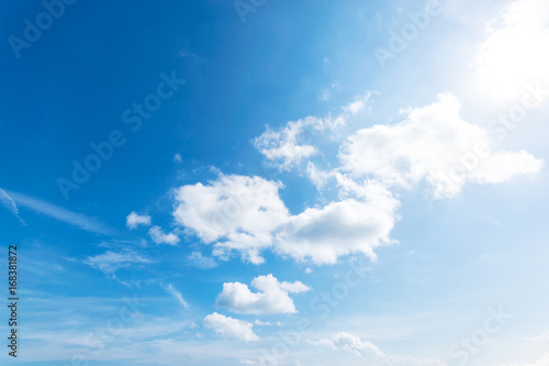 Blue sky background with the sun,Blue sky with white clouds floating in the sky. © Sky Stock