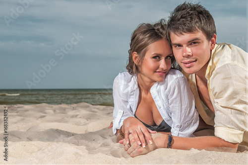 happy couple enjoying vacations on the beach