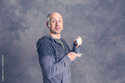 young baldheaded man drinking coffee