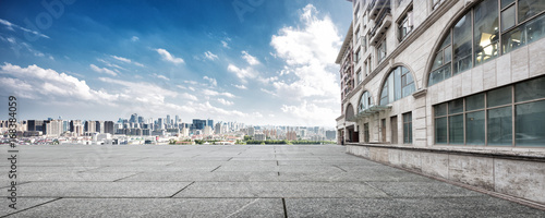 empty floor and cityscape of modern city against cloud sky