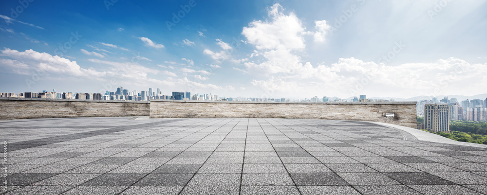 empty floor and cityscape of modern city against cloud sky