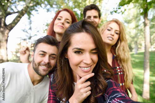 Group of friends taking selfie in urban background