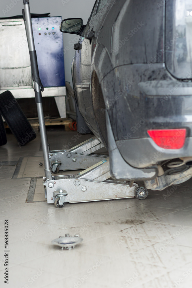 replacing the wheels on the SRT. the car is lifted on two jacks replacing the wheels on the SRT. the car is lifted on two jacks