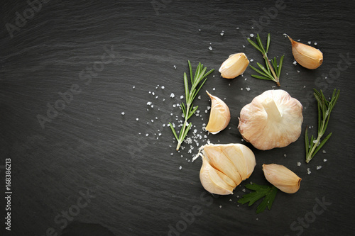 Image of garlic and rosemary on slate stone plate