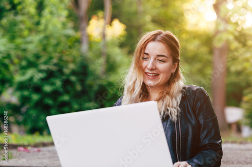 Beautiful Young Woman Working on Laptop Outside Her Office, Freelance Concept