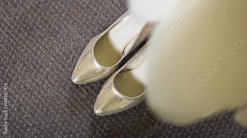 Top view of the silver pearl wedding shoes of the bride under the dress, HD footage