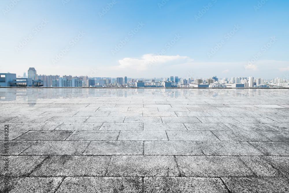 cityscape and skyline of hangzhou from empty brick floor