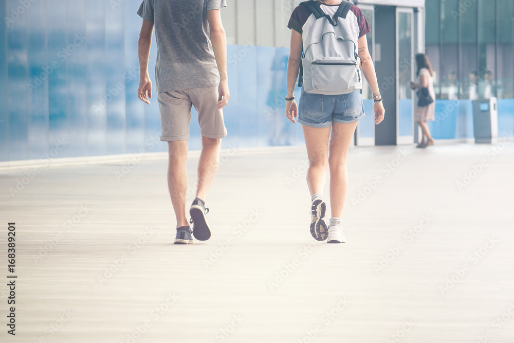 background image of two young people walking, modern building location with a lot of space for text and graphics background image of two young people walking, modern building location with a lot of space for text and graphics