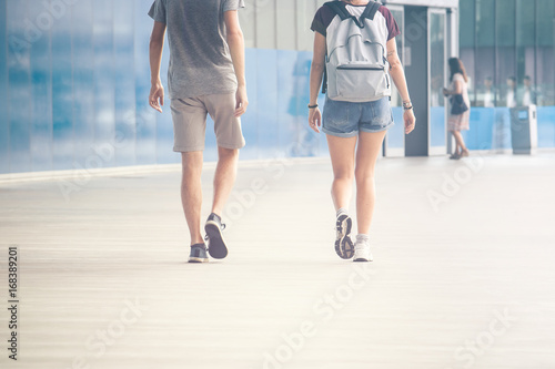 background image of two young people walking, modern building location with a lot of space for text and graphics