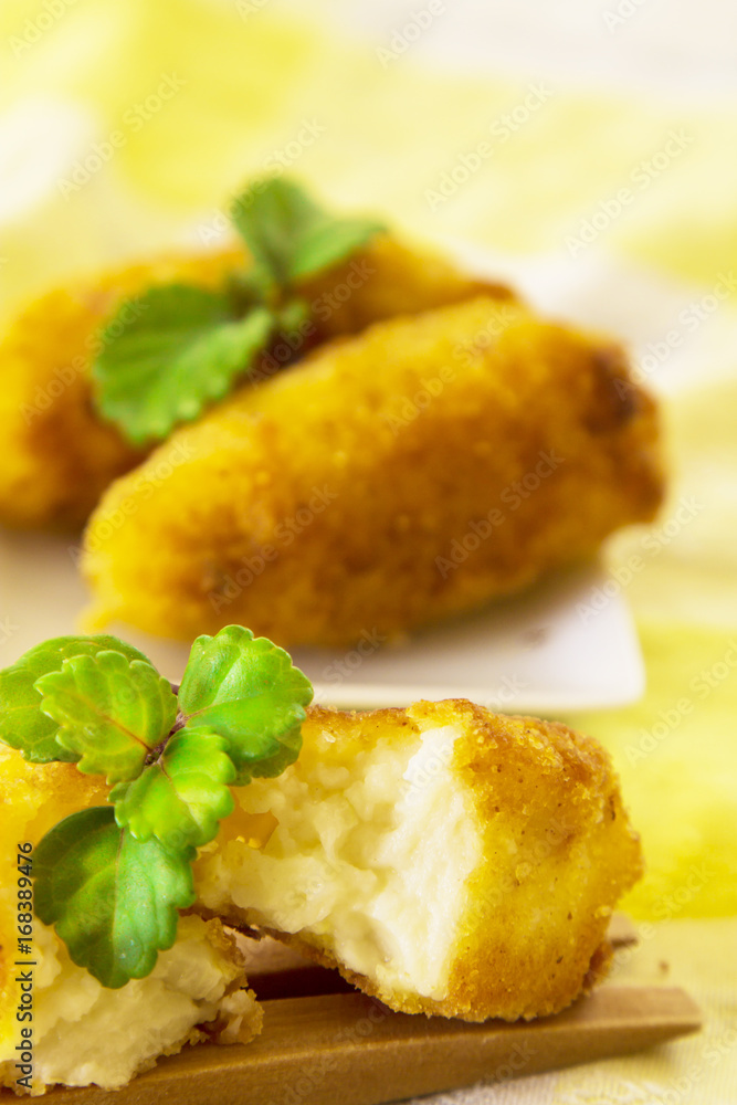 Stuffed croquettes on colorful tablecloth and wooden cutlery Stuffed croquettes on colorful tablecloth and wooden cutlery
