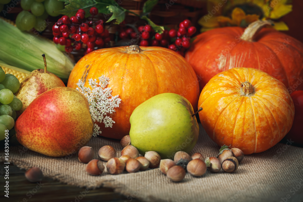 Happy Thanksgiving Day background, wooden table, decorated with vegetables, fruits and autumn leaves. Autumn background. Happy Thanksgiving Day background, wooden table, decorated with vegetables, fruits and autumn leaves. Autumn background.