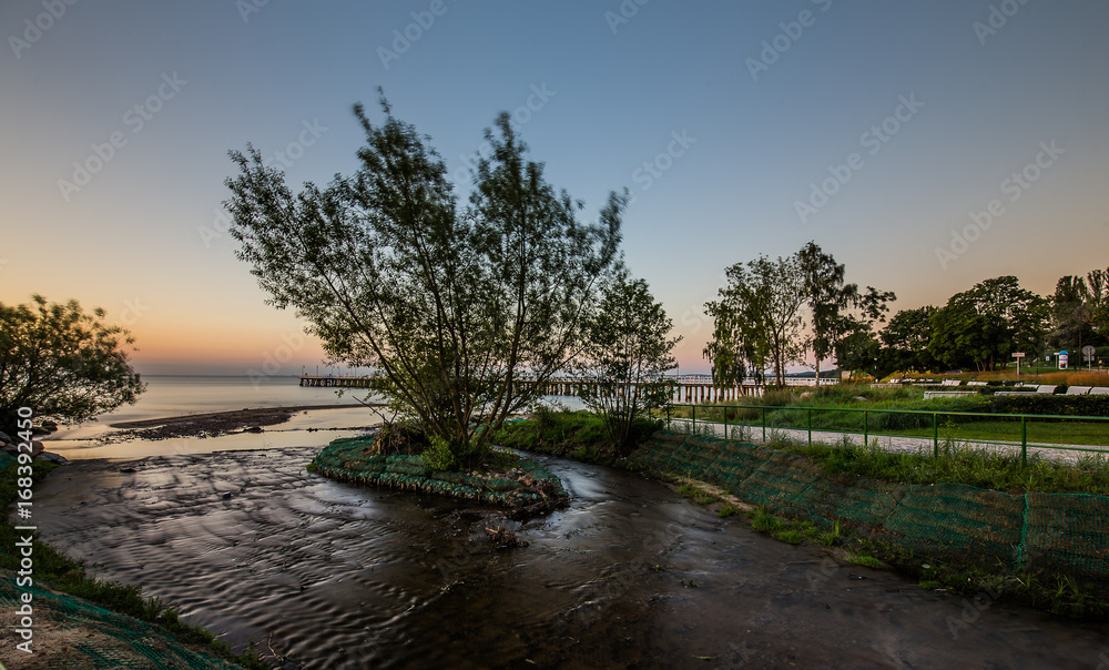 Fototapeta premium Amazing sunrise on the pier at the seaside. Gdynia Orlowo, Poland