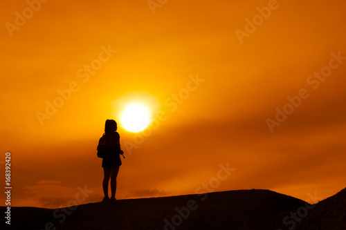 Young girl asian with backpack travel trip stand finish destinations on the mountain looking view sunset silhouette © Kiattisak