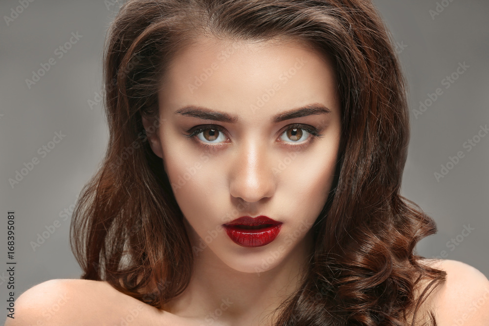Fototapeta premium Portrait of beautiful woman with red lips