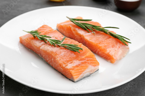 Fresh salmon fillet with rosemary on plate