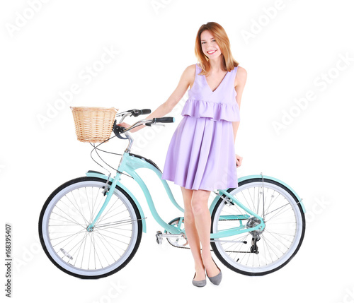 Young smiling girl with bicycle on white background © Africa Studio