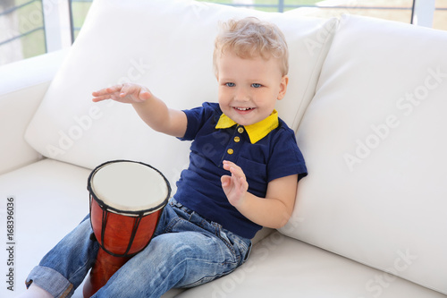 Cute little boy with drum o...
