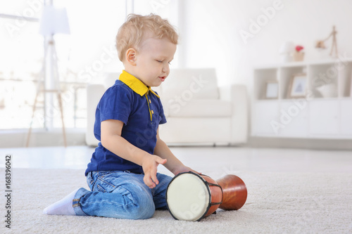 Cute little boy with drum o...