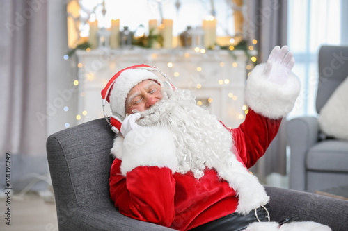 Santa Claus listening to mu...