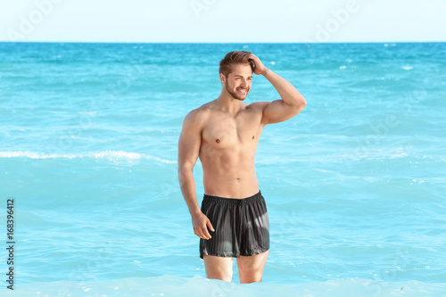Handsome young muscular man in sea