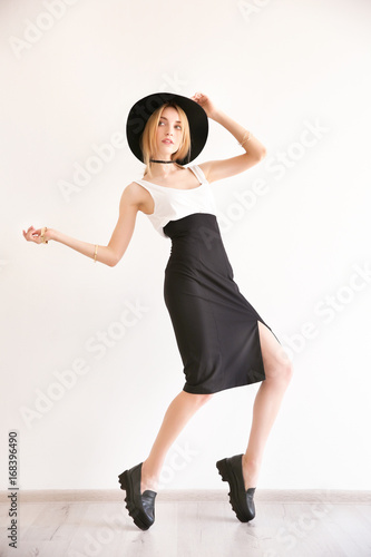 Obraz na plátně Beautiful young woman in stylish casual clothes near white wall