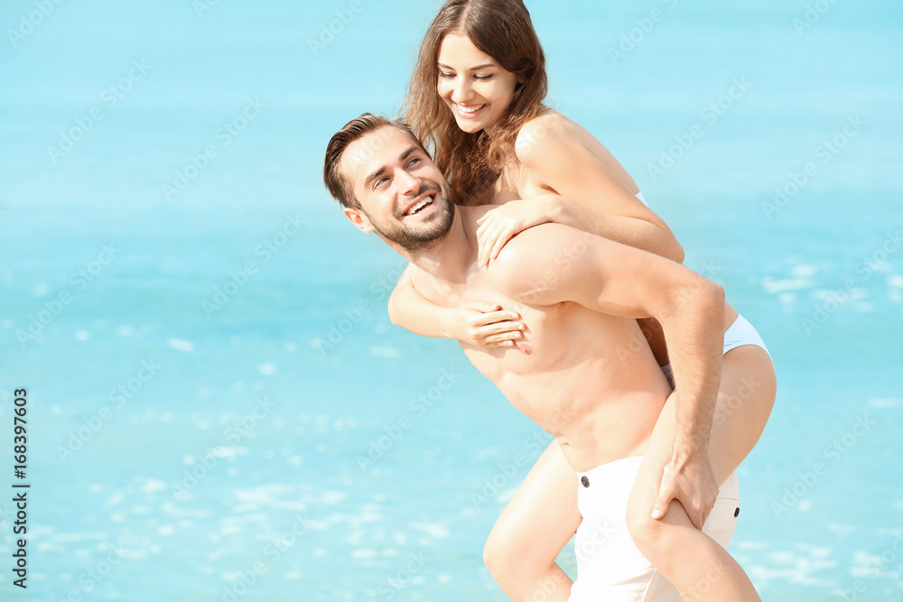Fototapeta premium Beautiful young couple at sea resort