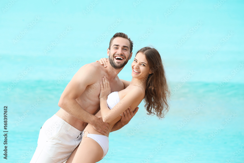 Beautiful young couple at sea resort