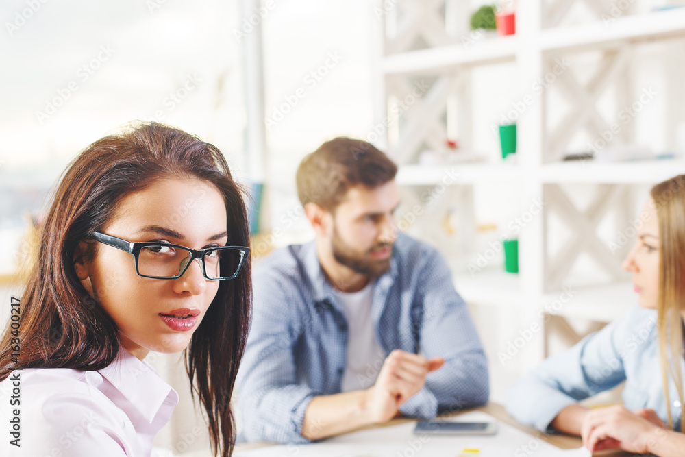 Portrait of woman with blurry colleagues Portrait of woman with blurry colleagues