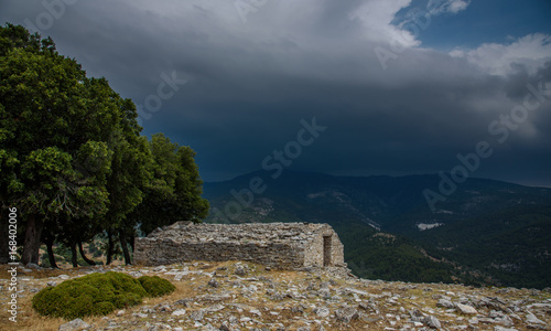 Ruins of an ancient church on a hilltop at Kastro, Thassos island - heavy summer storm approaching in the background