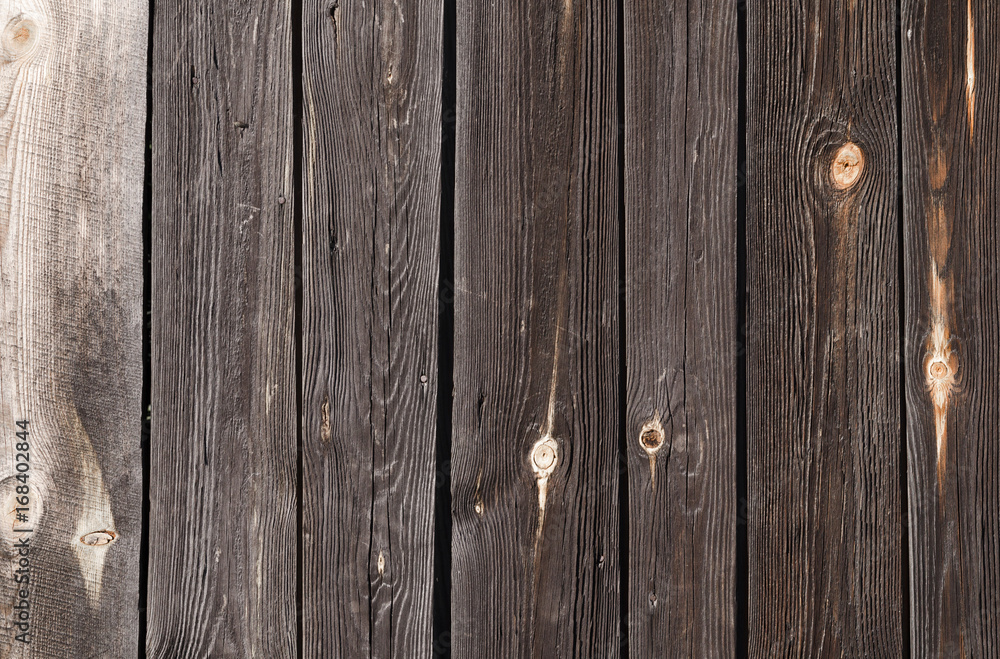 Fototapeta premium dark wooden planks with light spots, are located vertically