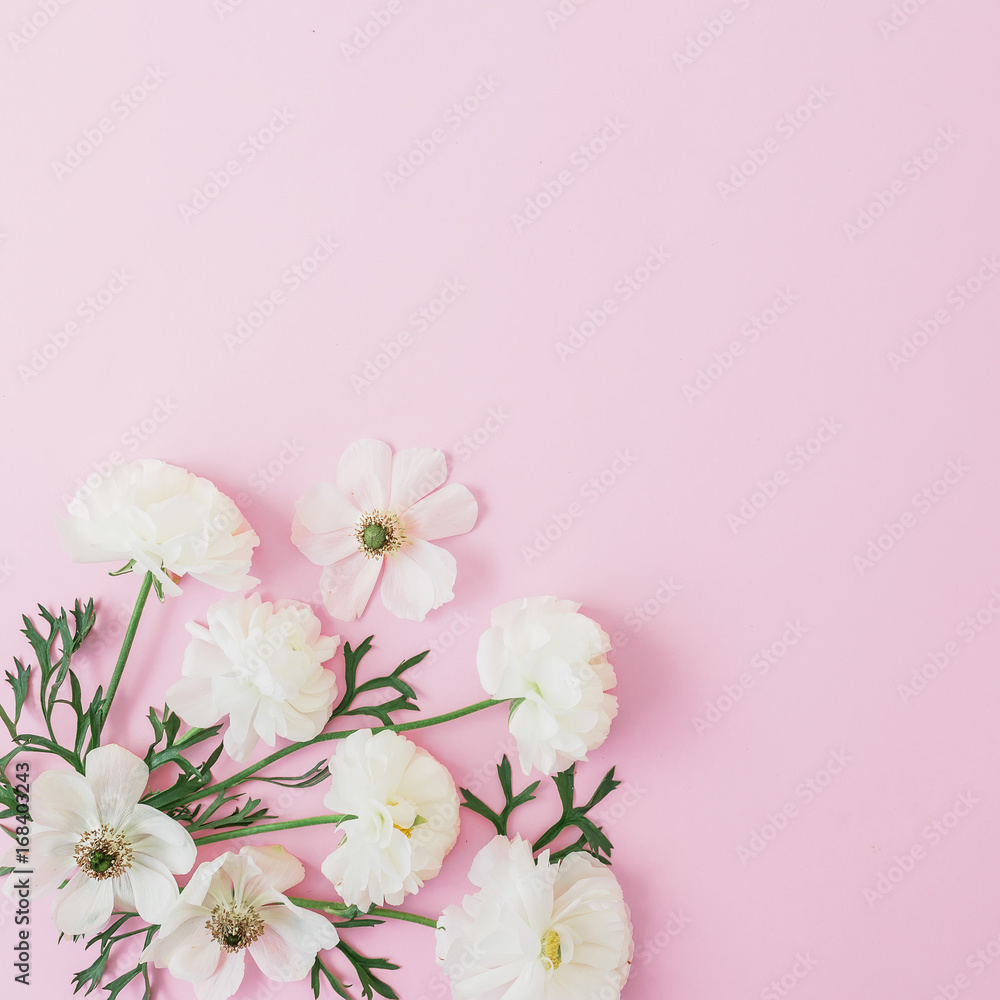 White flowers arrangement on pink background. Flat lay, top view. Flowers background.