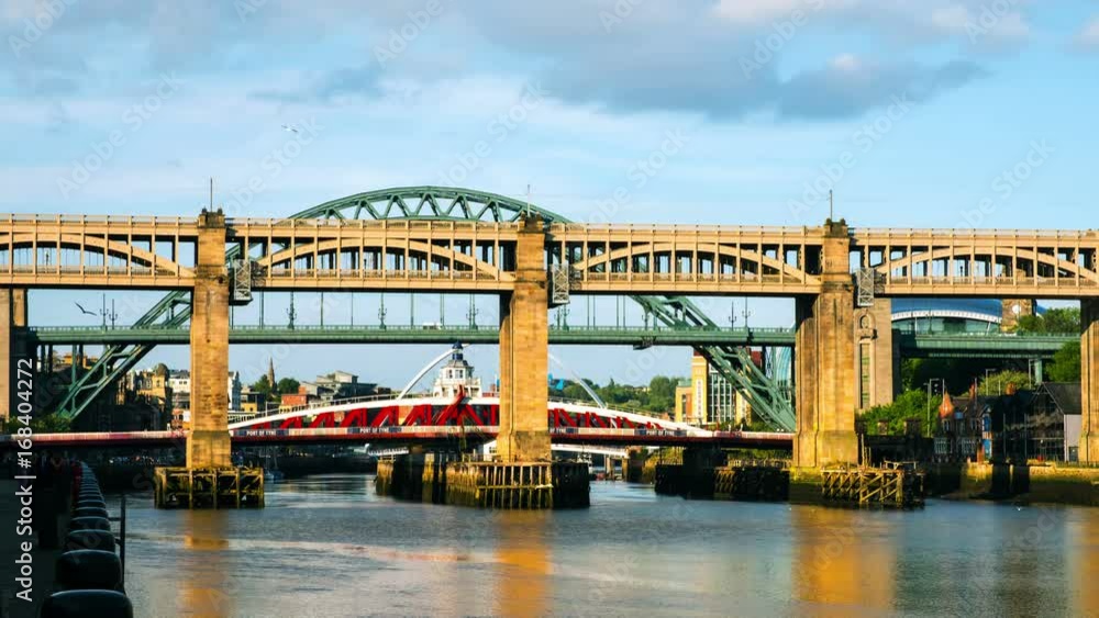 Newcastle upon Tyne, UK. The High Level Bridge in Newcastle upon Tyne, UK, over river Tyne during daytime with the Tyne Bridge behind it.Time-lapse with moving clouds Newcastle upon Tyne, UK. The High Level Bridge in Newcastle upon Tyne, UK, over river Tyne during daytime with the Tyne Bridge behind it.Time-lapse with moving clouds